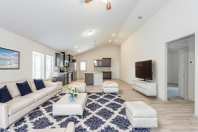 living room featuring ceiling fan and vaulted ceiling