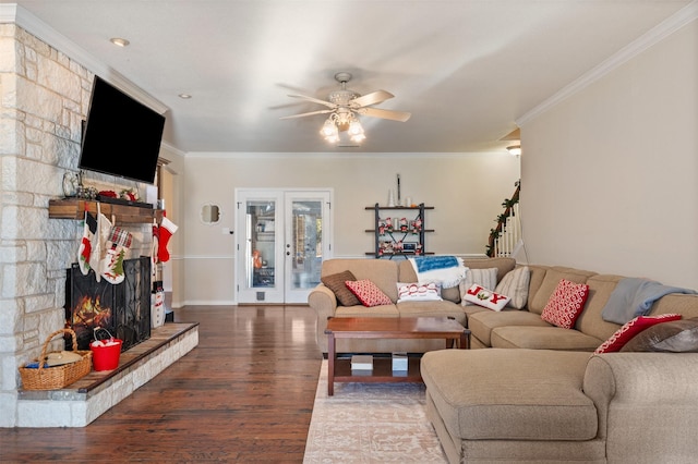 living room with ceiling fan, hardwood / wood-style floors, crown molding, and a fireplace