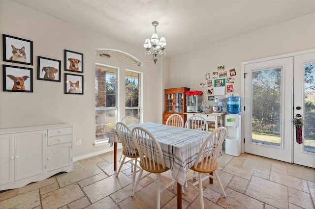 dining area featuring an inviting chandelier and french doors