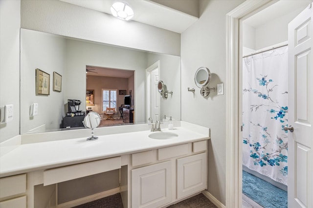 bathroom with vanity, ceiling fan, and walk in shower