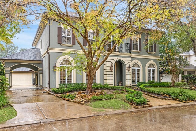 view of front of home with a garage and a balcony