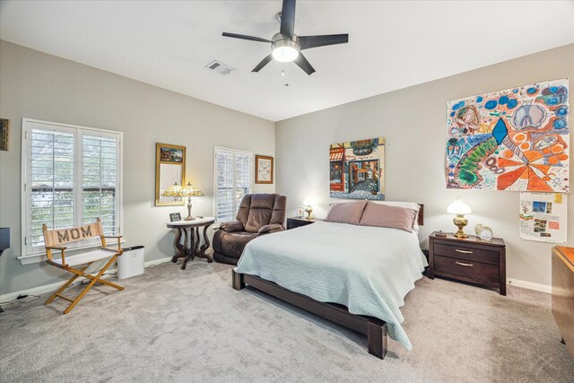 bedroom featuring light colored carpet and ceiling fan