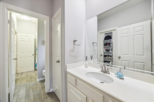 bathroom featuring vanity and toilet