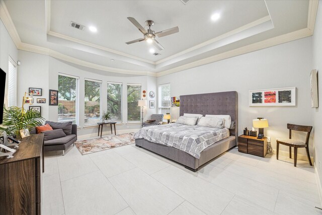 bedroom with light tile patterned floors, a tray ceiling, ornamental molding, and ceiling fan