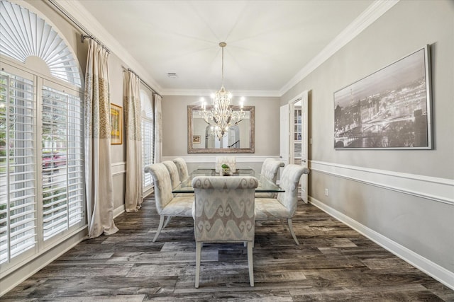 dining space featuring crown molding, an inviting chandelier, and dark hardwood / wood-style flooring