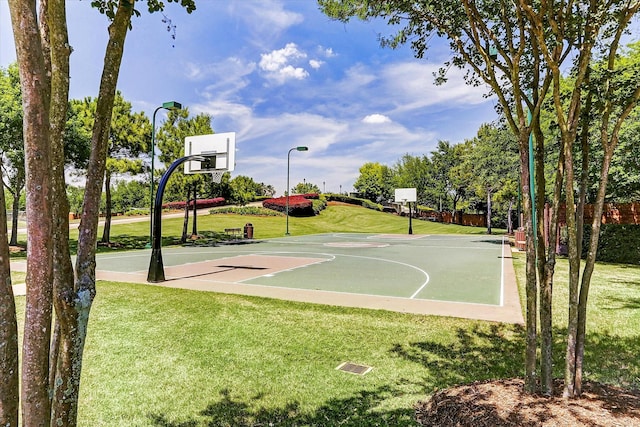 view of basketball court with a yard