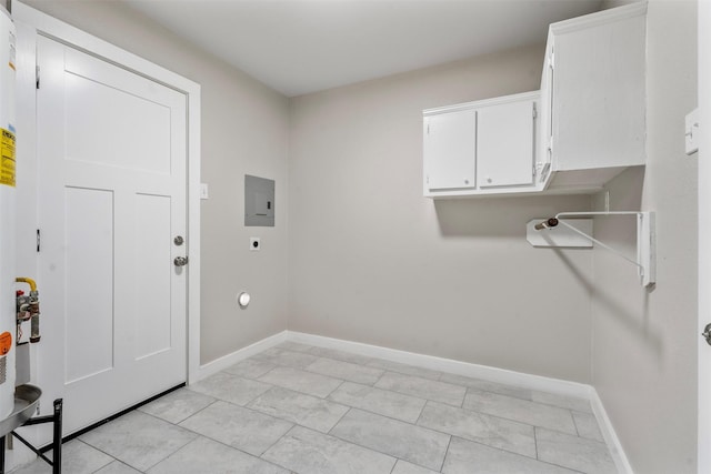 clothes washing area with cabinets, light tile patterned flooring, and hookup for an electric dryer