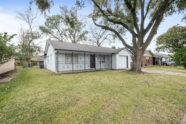 ranch-style house featuring a front yard, a garage, and central AC