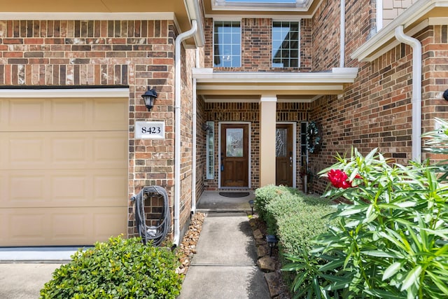 doorway to property with a garage