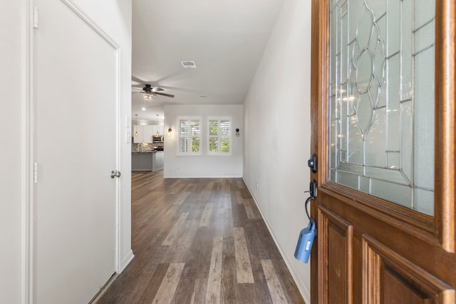 entryway featuring dark wood-type flooring and ceiling fan