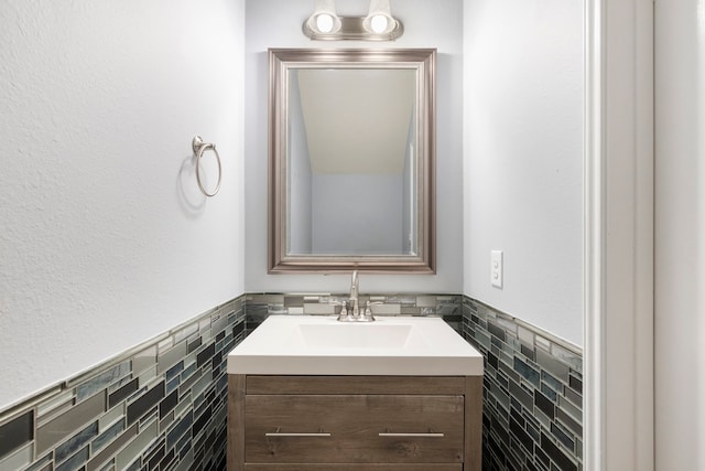 bathroom with vanity and tile walls