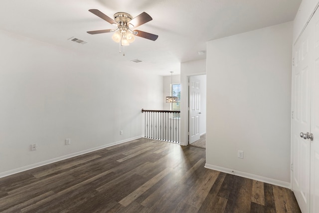 empty room featuring ceiling fan and dark hardwood / wood-style floors