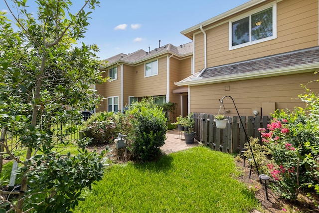 back of property featuring a patio area and a yard