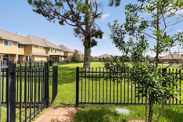 view of gate featuring a yard