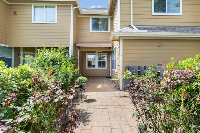 view of exterior entry with a patio area