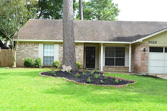 ranch-style home featuring a garage and a front lawn