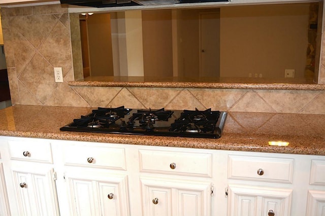 kitchen with white cabinetry, tasteful backsplash, black gas stovetop, and stone countertops