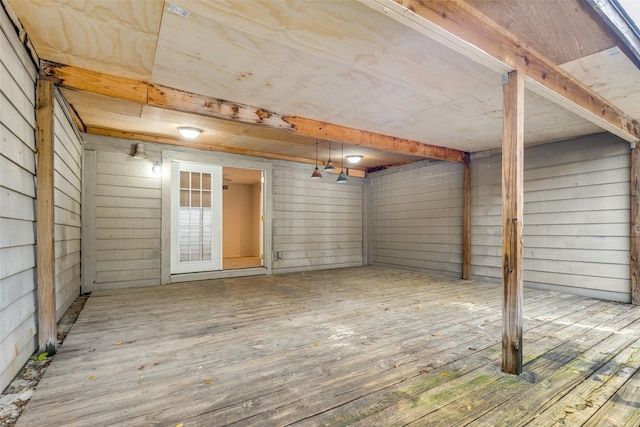 basement with wood walls and wood finished floors