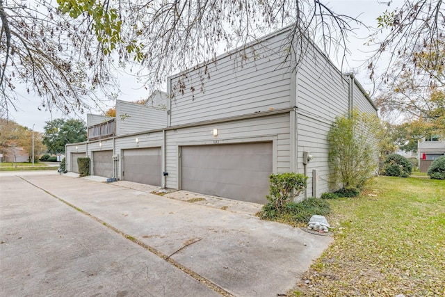 view of home's exterior with a garage and a yard