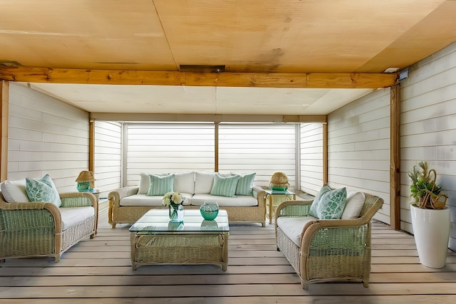 sunroom featuring beamed ceiling