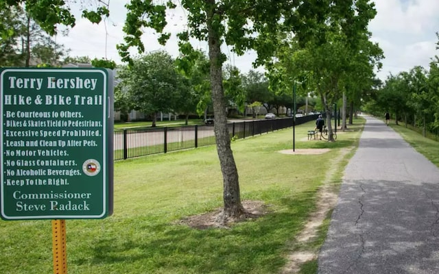 surrounding community with a yard and fence