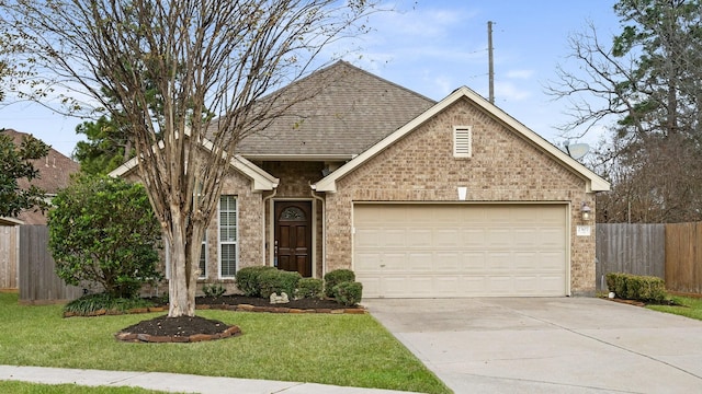 view of front of house featuring a front yard and a garage