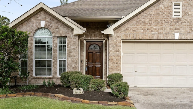 doorway to property with a garage