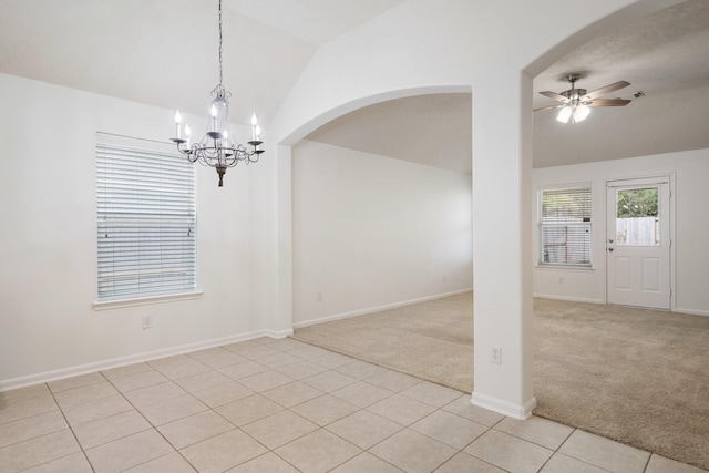 unfurnished room featuring vaulted ceiling, ceiling fan with notable chandelier, and light carpet