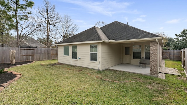 back of property with a patio area and a lawn