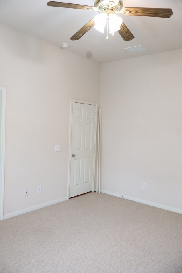 carpeted spare room with ceiling fan