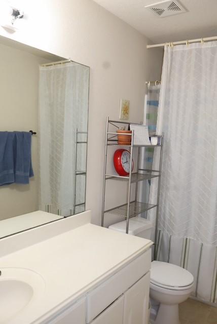 full bathroom featuring vanity, shower / tub combo, tile patterned flooring, and toilet