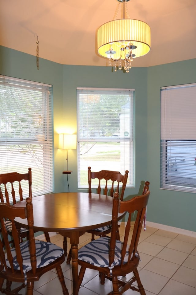 tiled dining area featuring a notable chandelier