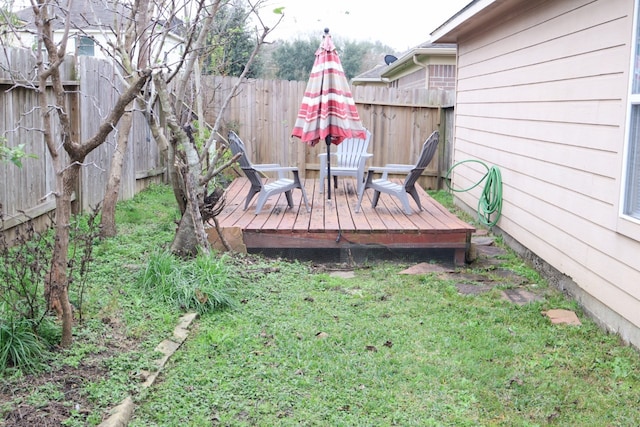 wooden terrace featuring a yard