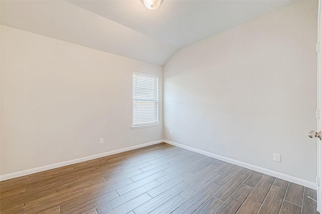 empty room featuring vaulted ceiling