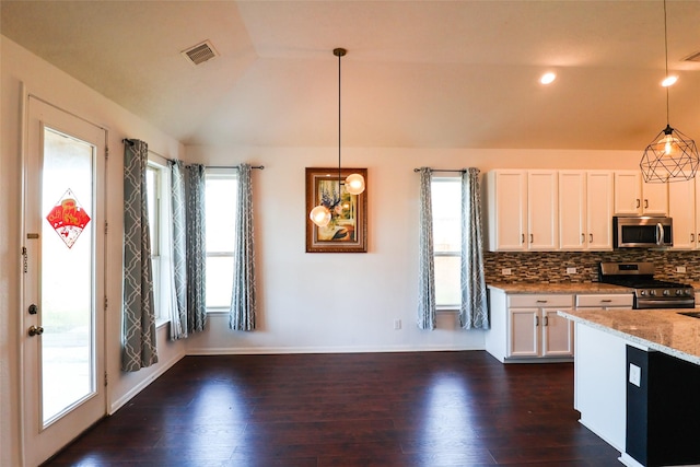 kitchen with white cabinetry, light stone counters, pendant lighting, and stainless steel appliances