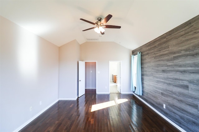 spare room with ceiling fan, dark hardwood / wood-style flooring, and lofted ceiling