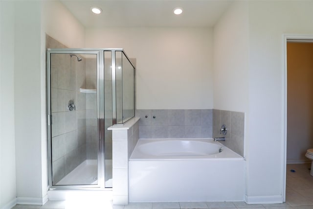 bathroom featuring toilet, tile patterned flooring, and plus walk in shower