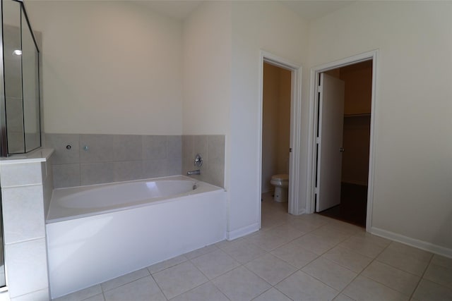 bathroom with toilet, tile patterned flooring, and a washtub