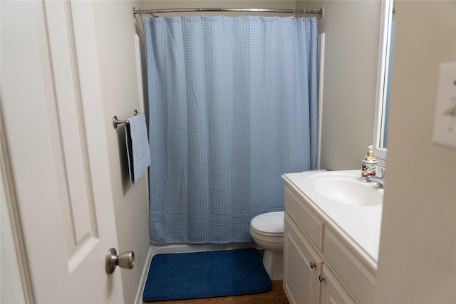 bathroom featuring hardwood / wood-style flooring, vanity, and toilet