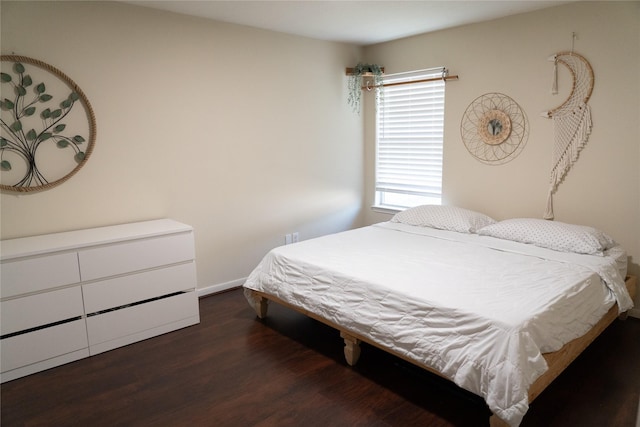 bedroom with dark hardwood / wood-style flooring