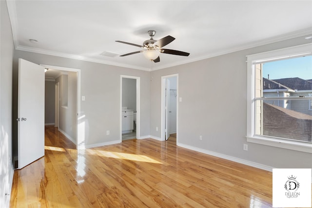 unfurnished bedroom featuring a spacious closet, ensuite bath, ceiling fan, light hardwood / wood-style flooring, and crown molding