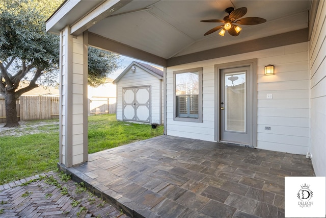 view of patio / terrace with ceiling fan and a storage unit