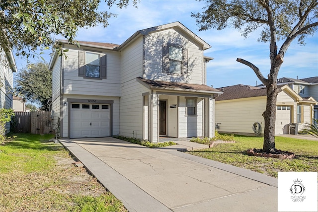 view of property featuring a front lawn and a garage