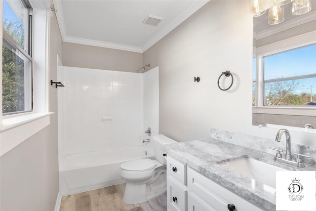 full bathroom with toilet, vanity, hardwood / wood-style flooring, tub / shower combination, and ornamental molding