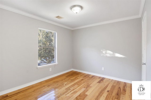 unfurnished room with crown molding and hardwood / wood-style floors