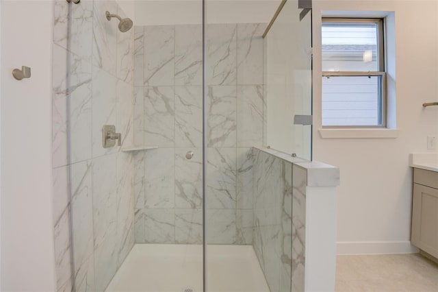 bathroom featuring a shower with shower door and vanity