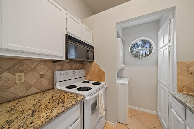 kitchen featuring backsplash, electric range, white cabinetry, light stone countertops, and light tile patterned floors