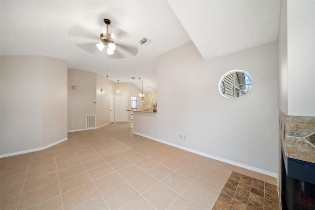 living room with ceiling fan, light tile patterned flooring, and lofted ceiling