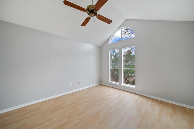 unfurnished room with vaulted ceiling, ceiling fan, and light hardwood / wood-style flooring