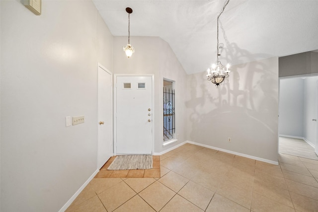 tiled foyer featuring an inviting chandelier and lofted ceiling